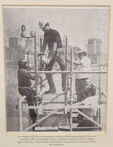 Crew installing electrical lights on a construction site.