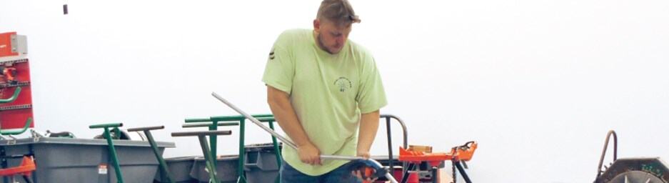 Electrical apprentice working outdoors at a job site.