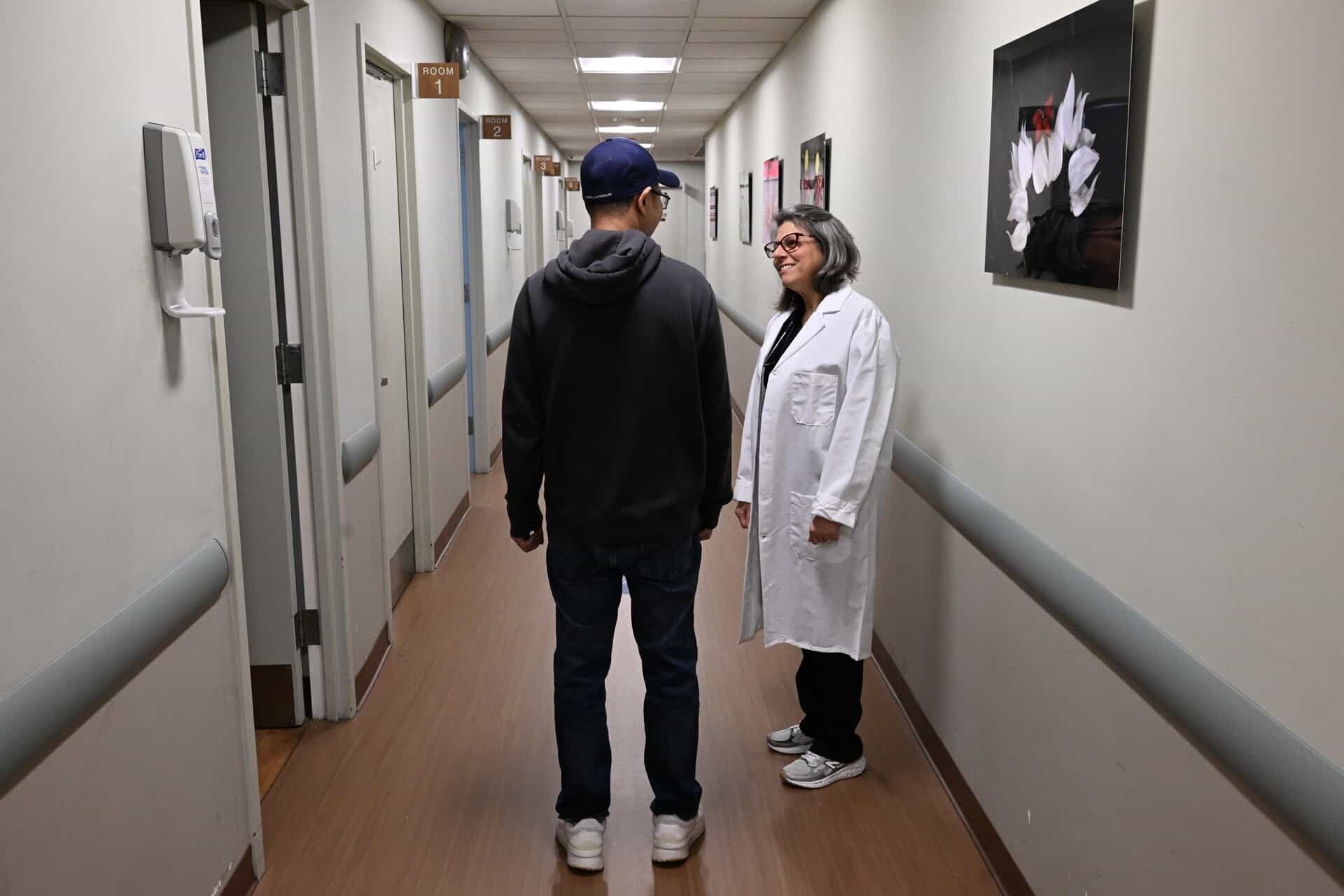 Electrical industry professionals consulting in a hospital corridor.