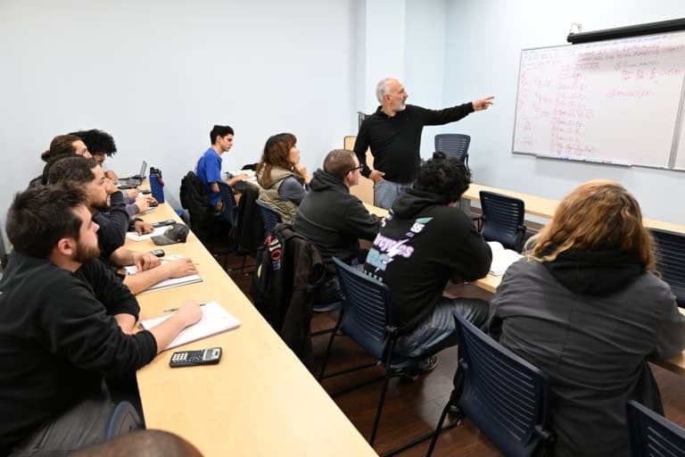 Electrical industry training session with instructor and students in classroom.