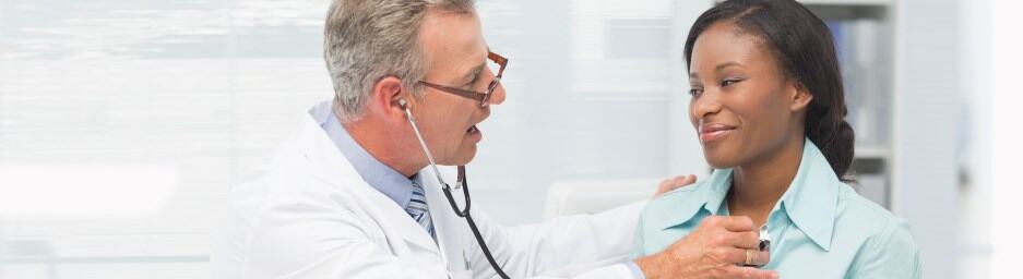 Healthcare professionals examining a patient in a medical setting.